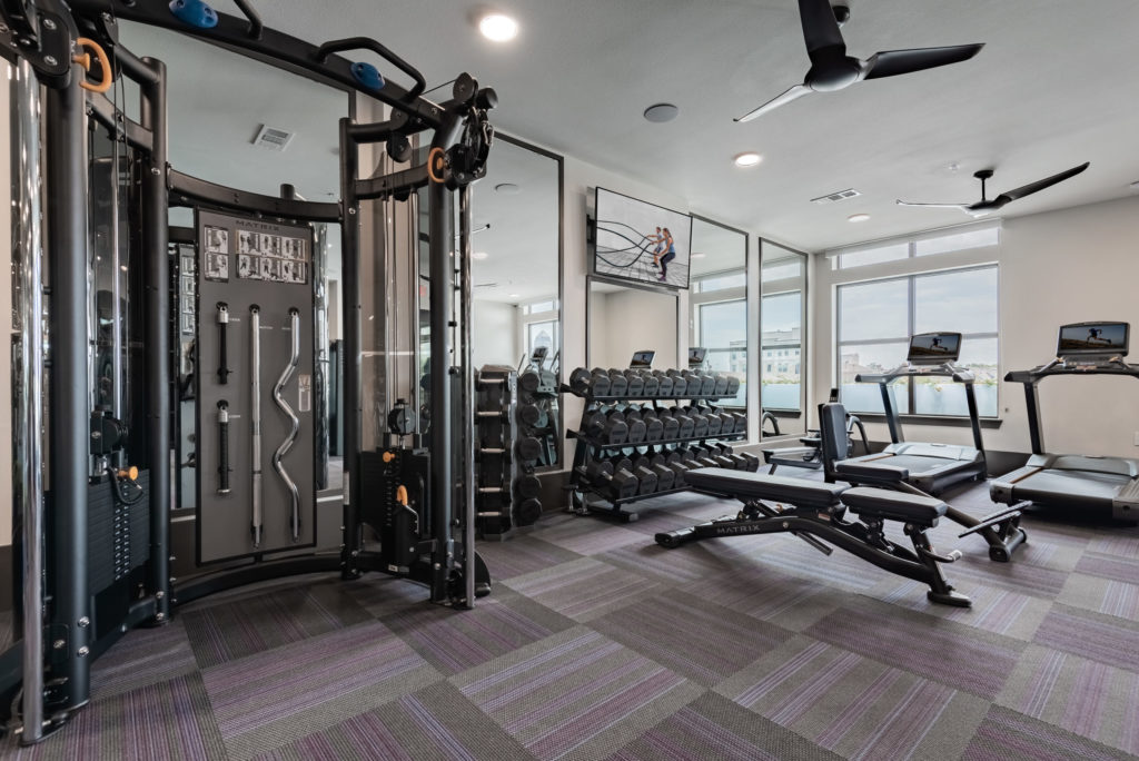 Maintain your active lifestyle in the fitness studio with strength and cardio equipment, yoga, and spin cycle studio - Decompress in Comfy Social Spaces