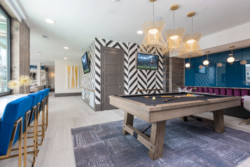 clubroom with views of the pool, TVs, suspended fireplace, a full kitchen, coffee bar, billiards, and shuffleboard - Upgrade Your Weekends in Uptown